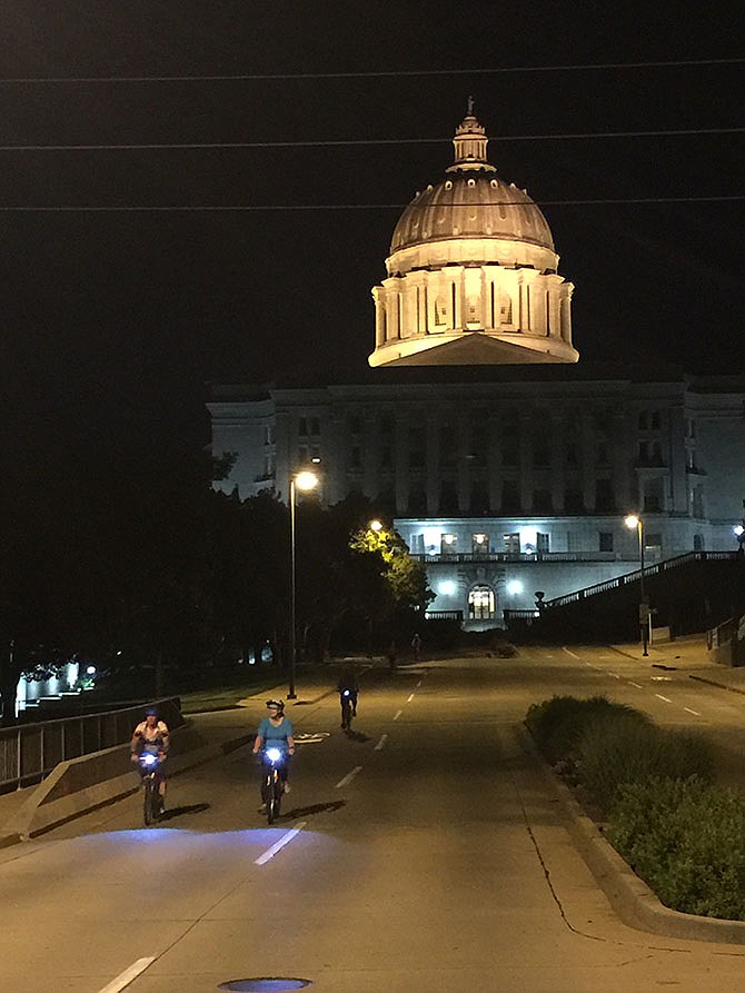 Cyclists head past the Capitol toward a break spot at Red Wheel Bike Shop June 19, 2016, during the early morning Tour de Jeff Moonlight Bike Ride.