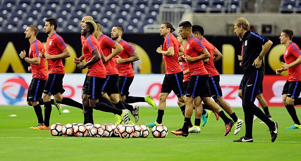 U.S. players go through drills during a training session Monday in Houston in preparation for tonight's game against Argentina.