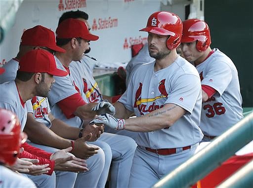 St. Louis Cardinals' Matt Holliday, second from right, celebrate in the dugout after hitting a two-run home run off Chicago Cubs starting pitcher Jason Hammel, also scoring Aledmys Diaz, right, during the third inning of a baseball game Tuesday, June 21, 2016, in Chicago. 