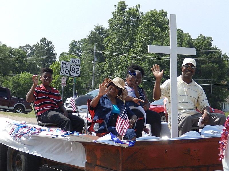  Among all the sports cars, tricked-out trucks, motorcycles and horses, this lone float carried these friendly people who waved at everyone along the parade route.