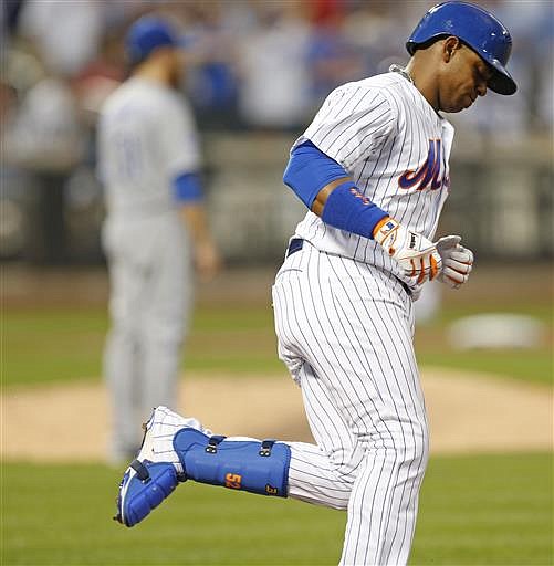 New York Mets Yoenis Cespedes trots the bases after hitting a fourth-inning, solo home run off Kansas City Royals starting pitcher Ian Kennedy, left, during a baseball game, Tuesday, June 21, 2016, in New York.