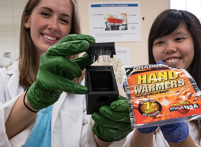 University of Texas students Rachel Boaz, left, and Szu Yu Liu hold up some components to their research project at the University of Texas on May 12, 2016 in Austin, Texas.