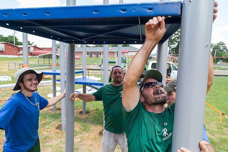 Brandon Croft of Clevenger Recreation tightens bolts Tuesday, June 21, 2016 for a platform that is part of what is described by a Texarkana, Ark., School District spokesperson as a new outdoor classroom at Fairview Elementary School. The new structure will have slides and a climbing wall. After the Fairview Elementary School project is finished, the team will begin construction at College Hill Middle School.