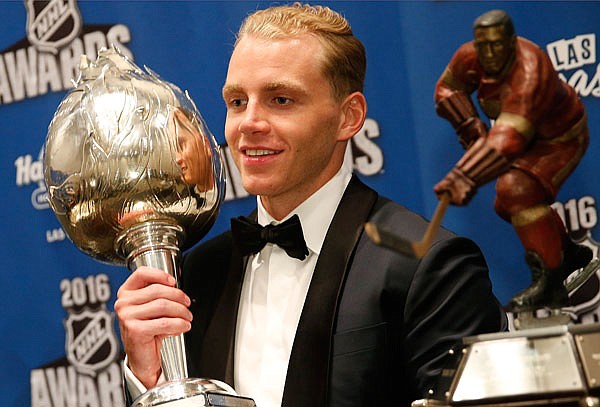 Patrick Kane of the Blackhawks poses with the Hart Trophy (left) and the Ted Lindsay Award after winning the awards Wednesday at the NHL Awards show in Las Vegas.