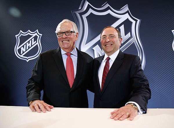 NHL Commissioner Gary Bettman (right) and Bill Foley pose for photographers during a news conference Wednesday in Las Vegas. Bettman announced an expansion franchise to Las Vegas after the league's board of governors met in Las Vegas. Foley is the majority owner of the team. 