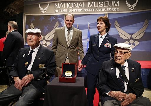 In this April 18, 2015 file photo two members of the Doolittle Tokyo Raiders, Staff Sgt. David Thatcher, front left, and Lt. Col. Richard "Dick" Cole, right, pose for photos with Lt. Gen. John "Jack" Hudson, rear left, Director National Museum of the United States Air Force, and Air Force Material Commander Gen. Janet C. Wolfenbarger, after the Congressional Gold Medal to the Doolittle Tokyo Raiders was presented to the National Museum of the United States Air Force at Wright-Patterson Air Force Base, in Dayton, Ohio. Thatcher, one of the last two surviving members of the Doolittle Raiders, who bombed Japan in retaliation for the attack on Pearl Harbor, has died in Montana. He was 94. 