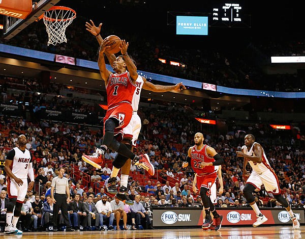 In this March 1, file photo, Bulls guard Derrick Rose goes past Heat forward Amar'e Stoudemire as he goes to the basket during a game in Miami. Rose was traded to the Knicks on Wednesday.