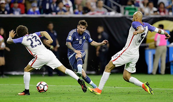 Lionel Messi of Argentina takes a shot on goal past Fabian Johnson (left) and Matt Besler of the United States during Tuesday's Copa America Centenario semifinal in Houston.