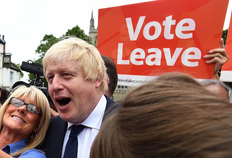 In this Wednesday, June 22, 2016, file photo, advocate to exit Europe Boris Johnson poses for a selfie photo with voters during a whistle stop tour of the country on the final day of campaigning before Thursday's EU referendum vote, in Selby, north England.