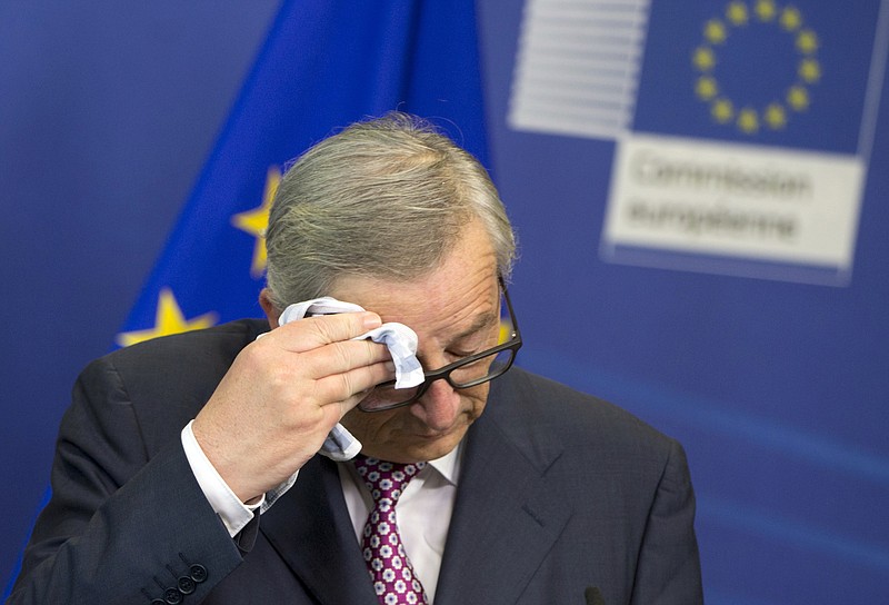 European Commission President Jean-Claude Juncker wipes his brow before speaking Wednesday, June 22, 2016, during a media conference at EU headquarters in Brussels.