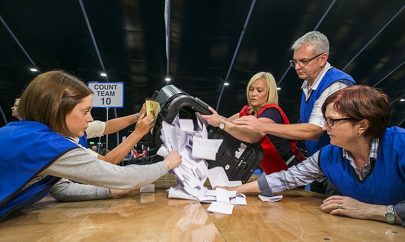 Countera begin to tally ballot papers at the Titanic Exhibition Centre in Belfast, Northern Ireland, as counting gets underway in the referendum on the UK membership of the European Union, late Thursday June 23, 2016. On Thursday Britain votes in a national referendum on whether to stay inside the EU.