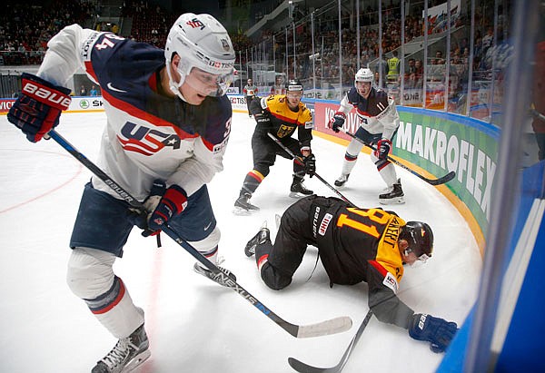 In this May 15, file photo, Auston Matthews of the United States fights for the puck with Torsten Ankert of Germany during a Hockey World Championships Group B match in St. Petersburg, Russia. 