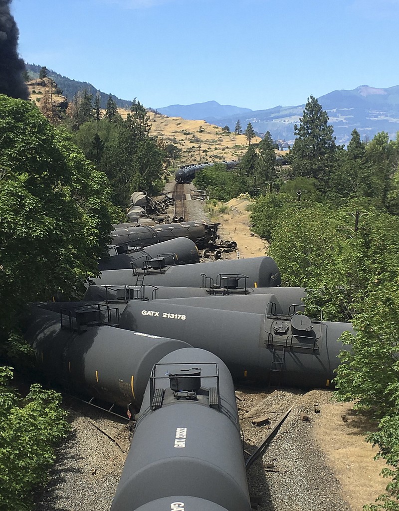 In this June 3, 2016, file photo provided by Silas Bleakley, tank cars carrying oil, are derailed near Mosier, Ore. Federal investigators on Thursday, June 23, 2016, blamed Union Pacific Railroad for the derailment along the Oregon-Washington border, saying the company failed to properly maintain its track. Preliminary findings on the derailment raise questions about why the company didn't find the broken bolts that triggered the wreck when it inspected the tracks right before the derailment.