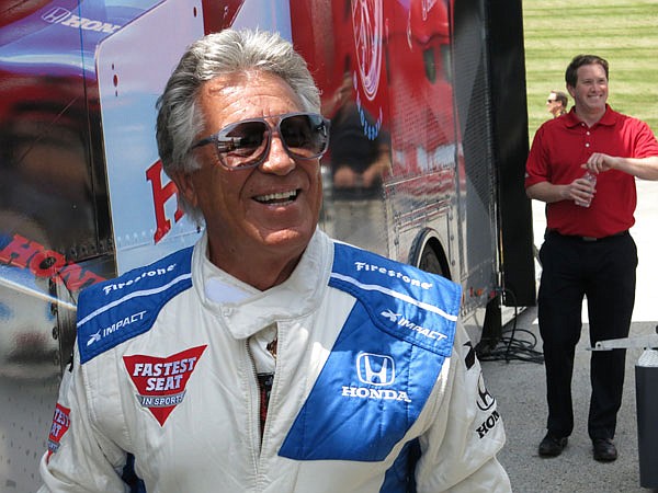 Retired IndyCar driver Mario Andretti walks out of a trailer Wednesday at Road America in Elkhart Lake, Wis. IndyCar is returning to Road America for the first time since 2007 on Sunday.