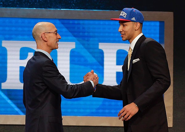 NBA commissioner Adam Silver (left) greets Ben Simmons after announcing him as the top pick by the 76ers during the NBA draft Thursday in New York.