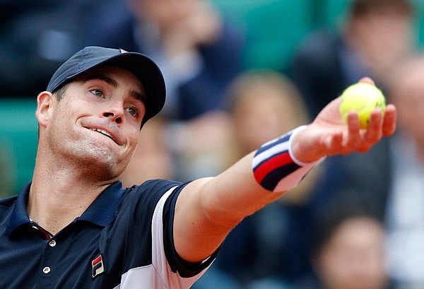 In this May 29, file photo, John Isner serves to Andy Murray at the French Open at Roland Garros stadium in Paris. 