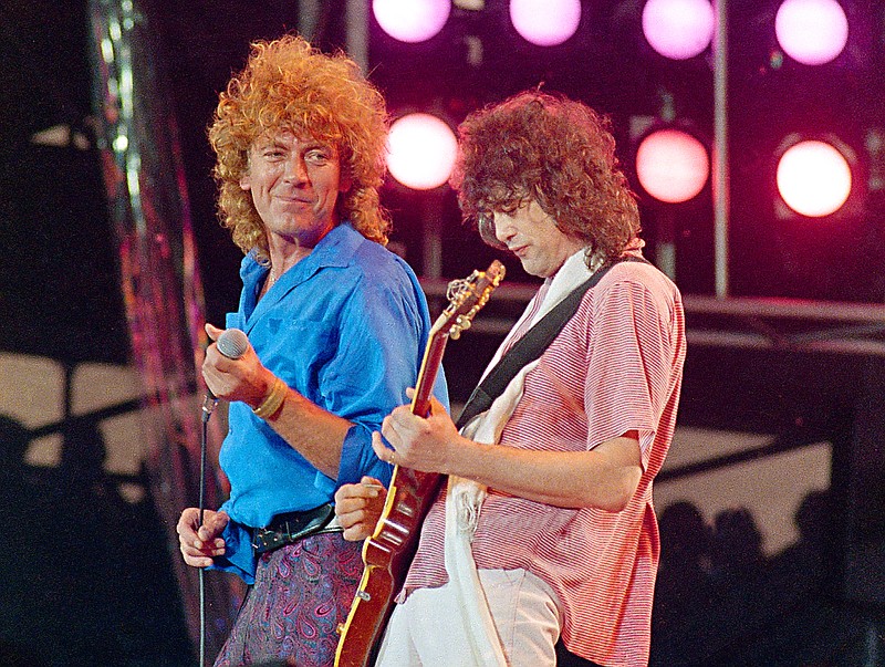 In this July 13, 1985 file photo, Led Zeppelin bandmates, singer Robert Plant, left, and guitarist Jimmy Page, reunite to perform for the Live Aid famine relief concert at JFK Stadium in Philadelphia.  A federal court jury decided Thursday, June 23, 2016 that the band did not steal a riff from an obscure 1960s instrumental tune to use for the introduction of its classic rock anthem "Stairway to Heaven."