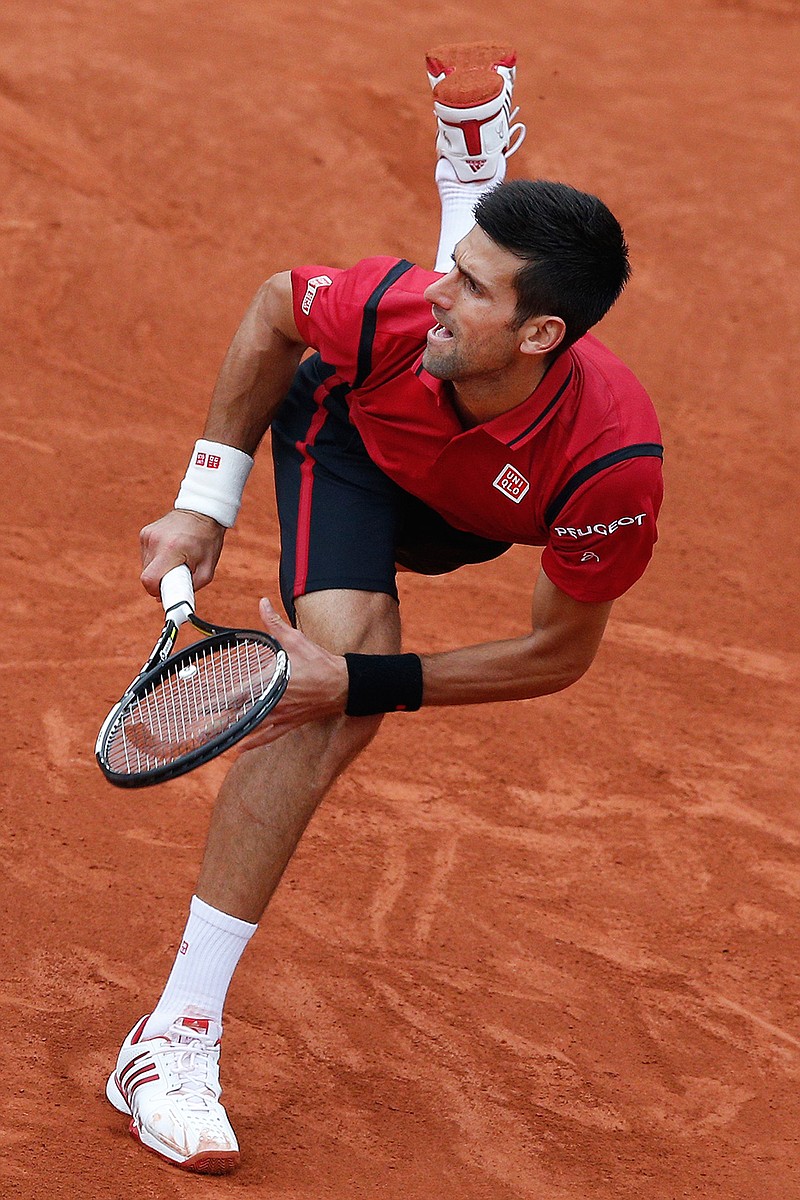 Serbia's Novak Djokovic returns the ball in the final of the French Open tennis tournament against Britain's Andy Murray at the Roland Garros stadium in Paris, France, Sunday, June 5, 2016. 