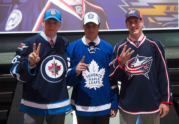 The NHL top three draft picks, Patrik Laine, Winnipeg Jets; Auston Matthews, Toronto Maple Leafs; and Pierre-Luc Dubois, Columbus Blue Jackets, pose for a photo at the NHL draft Friday in Buffalo, N.Y. 