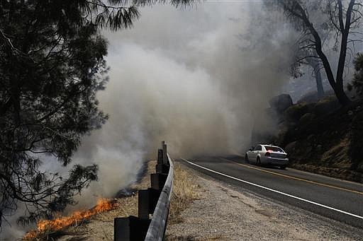A wildfire burns on the hillside of Lake Isabella, Calif., Friday, June 24, 2016. The wildfire that roared across dry brush and trees in the mountains of central California gave residents little time to flee as flames burned homes to the ground, propane tanks exploded and smoke obscured the path to safety.