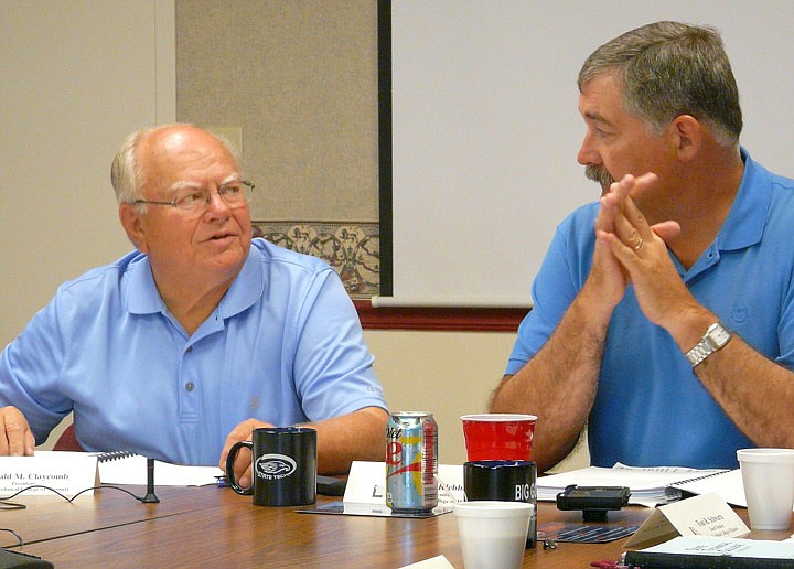 Don Claycomb, left, who retires this week after 23 years as president of State Technical College of Missouri in Linn, visits with Regents President John Klebba at the start of Friday's board meeting.