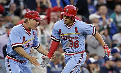 St. Louis Cardinals' Aledmys Diaz (36) is congratulated by third base coach Chris Maloney on his three-run home run against the Seattle Mariners in the fifth inning of a baseball game Saturday, June 25, 2016, in Seattle.