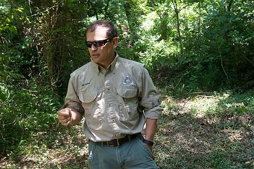 Rick Horton, with the Missouri Department of Conservation, talks about the Ozark cavefish near the entrance to a cave in Sarcoxie, Mo., on June 16, 2016. The cavefish was discovered in the 1880s by Ruth Hoppin, who was staying in Missouri on a health sabbatical. (Roger Nomer/The Joplin Globe via AP)