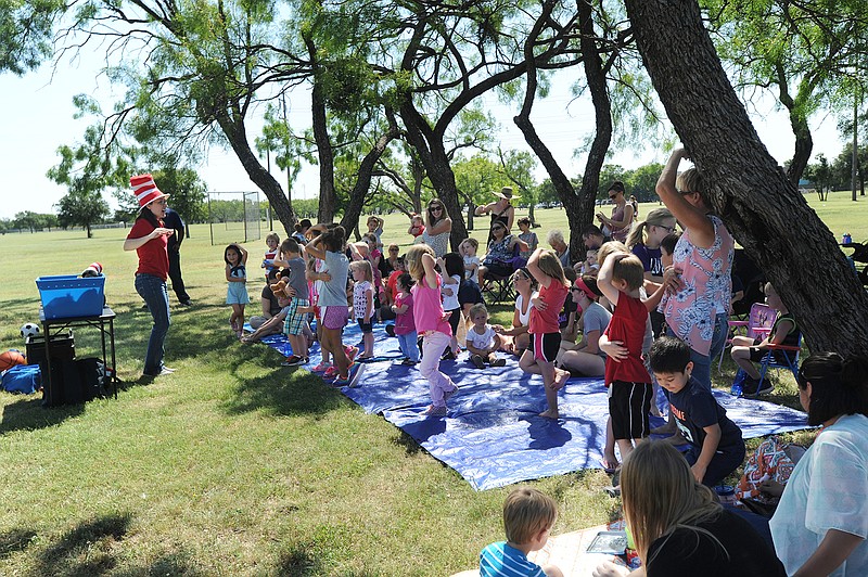 Kids stretch during a reading of several Dr. Seuss books at the Stories in the Park Thursday, June 23, 2016, in Abilene, Texas.