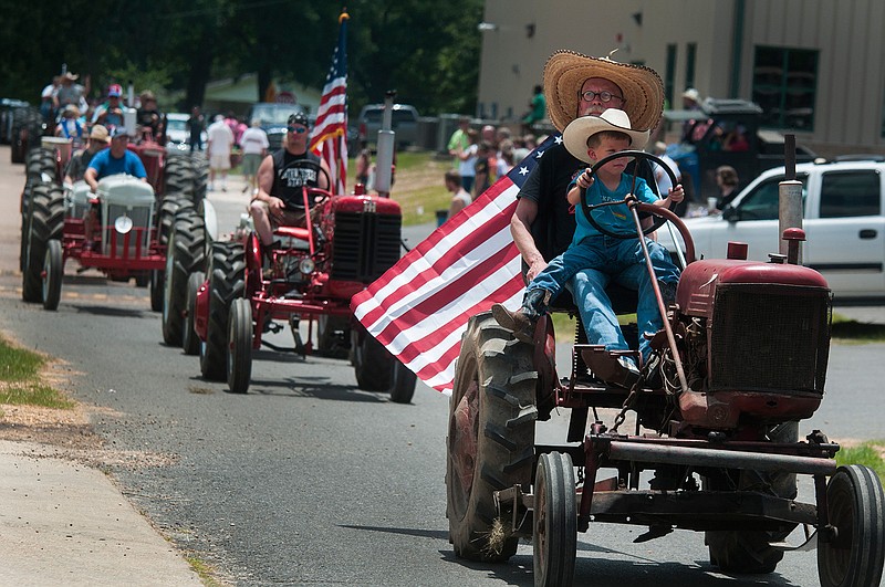 Tractors line the road during a parade Saturday, June 25, 2016 at the Purple Hull Pea Festival in Emerson, Ark. 