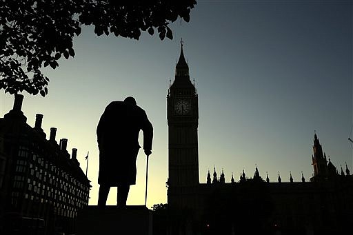 A statue of Winston Churchill is silhouetted against the Houses of Parliament in London, Friday morning, June 24, 2016. Britain's  vote to leave the European Union adds uncertainty to a world economy that is still struggling to reach full speed years after the global financial crisis.