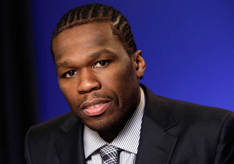 In this Oct. 26, 2011 file photo, Rapper and businessman Curtis Jackson III, known as 50 Cent, poses during an interview in New York. Police in St. Kitts and Nevis say that U.S. rapper 50 Cent and a member of his entourage were detained and charged for allegedly using "indecent language" during his performance at the St. Kitts Music Festival, Saturday, June 25, 2016. 
