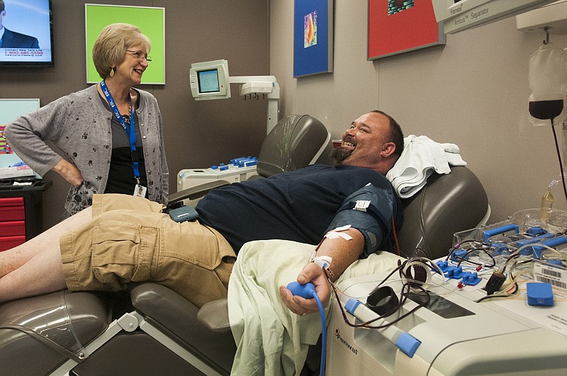 LifeShare Blood Center manager Theresa Westbrook checks on James Garrett as he donates platelets and plasma Monday, at the center. Summer tends to leave the center short on blood and looking for new donors. 
