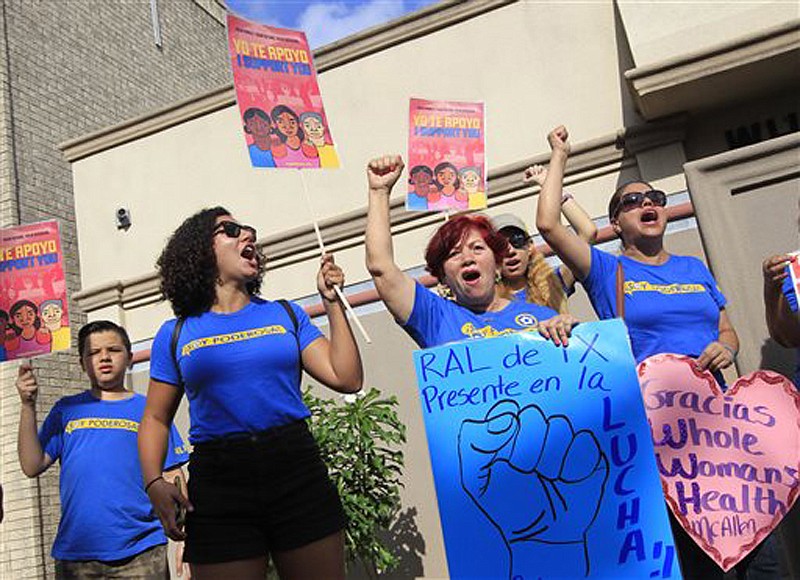 Members of the National Institute for Reproductive Health celebrate the U.S. Supreme Court ruling against Texas' abortion restrictions in front of Whole Woman's Health Monday in McAllen, Texas. Whole Woman's Health is an abortion provider that stayed open despite the restrictions as many other providers closed over the past two years.