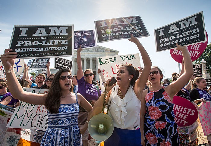 Reagan Barklage, of St. Louis, center, and other anti-abortion activists demonstrate in front of the Supreme Court on Monday as the justices struck down the strict Texas anti-abortion restriction law known as HB2. 