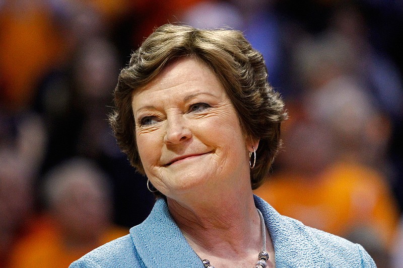 In this Jan. 28, 2013, file photo, former Tennessee women's basketball coach Pat Summitt smiles as a banner is raised in her honor before the team's NCAA college basketball game against Notre Dame in Knoxville, Tenn. Summitt, the winningest coach in Division I college basketball history who boosted women's game, has died at 64.