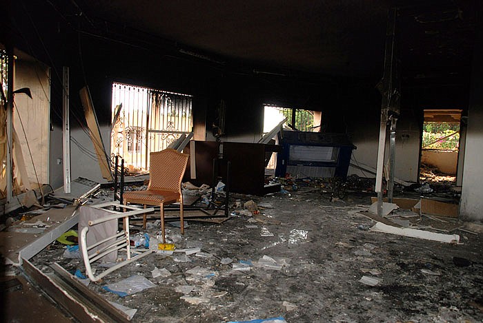 A 2012 photo shows glass, debris and overturned furniture are strewn inside a room in the gutted U.S. consulate in Benghazi, Libya, after an attack that killed four Americans.