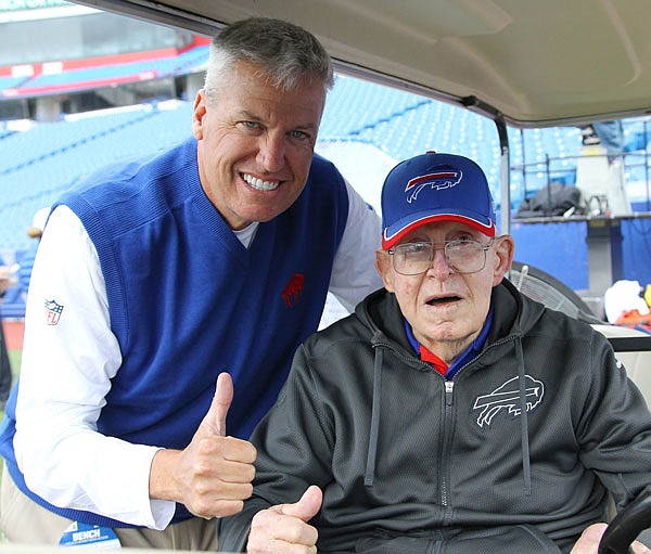 In this Sept. 13, 2015, file photo, Bills head coach Rex Ryan (left) visits with his father, Buddy Ryan, before an NFL game against the Colts in Orchard Park, N.Y. Buddy Ryan, who coached two defenses that won Super Bowl titles and whose twin sons, Rex and Rob, also have been successful NFL coaches, died Tuesday. He was 85.