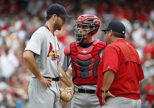 St. Louis Cardinals starting pitcher Michael Wacha, left, catcher Eric Fryer, center, and pitching coach Derek Lilliquist talk on the mound during the fourth inning of a baseball game against the Washington Nationals at Nationals Park, Sunday, May 29, 2016, in Washington. 