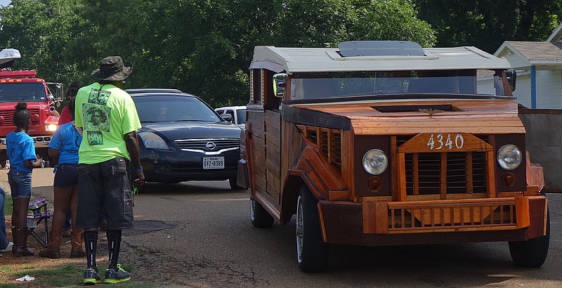 In a line of cars, who wouldn't be attracted to Wayne Mathews' handmade wooden car that has the look of a modern antique? The car was shown in the recent Juneteenth celebration in Atlanta.