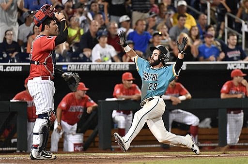 Coastal Carolina's Anthony Marks (29) scores on a Connor Owings single against Arizona in the eighth inning in Game 2 of the NCAA Men's College World Series finals baseball game in Omaha, Neb., Tuesday, June 28, 2016. 