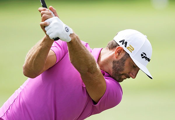 Dustin Johnson hits from the practice range during Wednesday's practice round of the Bridgestone Invitational at Firestone Country Club in Akron, Ohio.