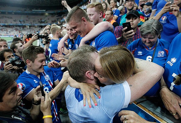 Iceland's players celebrate with fans at the end of Monday's Euro 2016 round of 16 game between England and Iceland at the Allianz Riviera stadium in Nice, France.