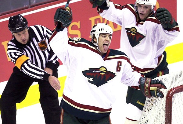 In this March 11, 2001, file photo, Minnesota Wild's Marian Gaborik (right) moves in to celebrate with teammate Darby Hendrickson (center) after Hendrickson scored a goal against the Red Wings in the first period of an NHL  game. The Wild, part of the previous wave of expansion when they entered the NHL in 2000, used a well-respected coach in Jacques Lemaire and a tight-knit team to reach the Western Conference finals in their third season.