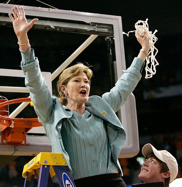 In this April 8, 2008, file photo, Tennessee coach Pat Summitt holds up the net as her son, Tyler, looks on after Tennessee beat Stanford 64-48 to win its eighth national women's basketball championship in Tampa, Fla.  Summitt, the winningest coach in Division I college basketball history, died Tuesday morning. She was 64.