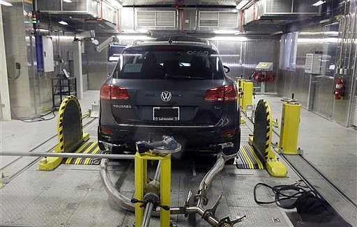 In this Oct. 13, 2015, file photo, a Volkswagen Touareg diesel is tested in the Environmental Protection Agency's cold temperature test facility in Ann Arbor, Mich. Volkswagen will spend more than $15 billion to settle consumer lawsuits and government allegations that it cheated on emissions tests in what lawyers are calling the largest auto-related class-action settlement in U.S. history. The settlement was revealed Tuesday, June 28, 2016, by a U.S. District Court in San Francisco.