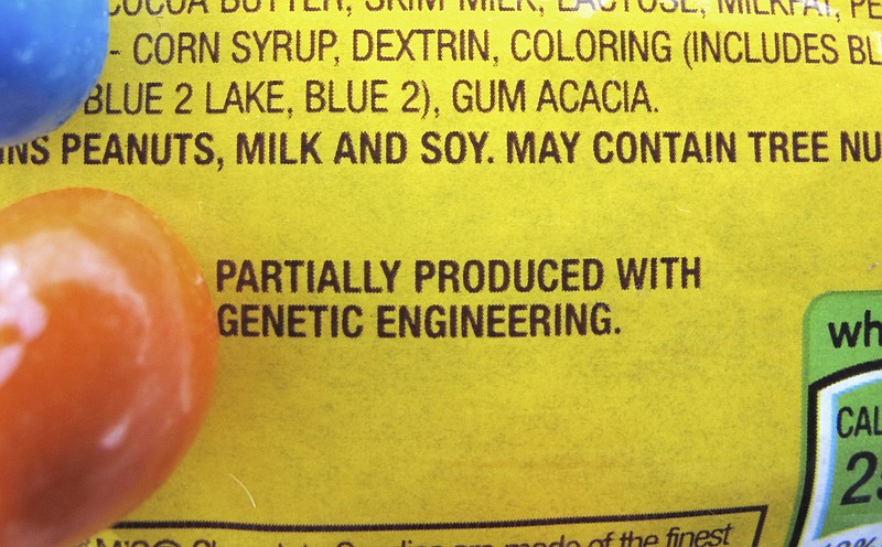 This photo shows a new disclosure statement which reads, "PARTIALLY PRODUCED WITH GENETIC ENGINEERING" on a package of candy in Montpelier, Vt. On Friday, July 1, 2016, Vermont will become the first U.S. state to require the labeling of foods made with genetically modified ingredients. 