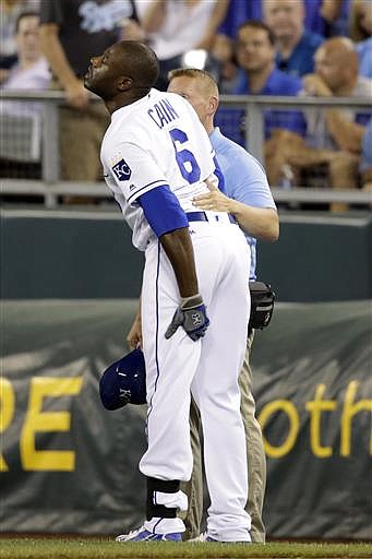 Kansas City Royals Lorenzo Cain reacts after injuring his leg running to first base in the ninth inning of a baseball game against the St. Louis Cardinals at Kauffman Stadium in Kansas City, Mo., Tuesday, June 28, 2016. The Cardinals beat the Royals 8-4. 