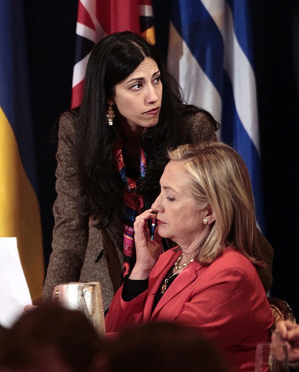 Huma Abedin, top, deputy chief of staff and aide to then-Secretary of State Hillary Rodham Clinton, right, are seen during a 2011 meeting with leaders for the Open Government Partnership in New York.  