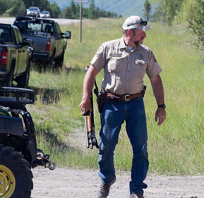 Montana warden Perry Brown prepares to hunt for a grizzly bear that killed Forest Service law enforcement officer Brad Treat near West Glacier, Montana, on Wednesday.