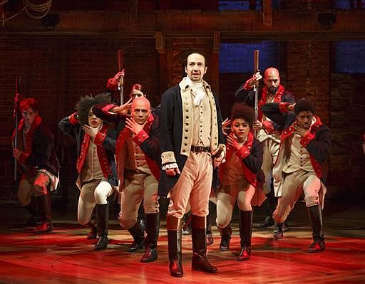  In this photo released by The Public Theater, Lin-Manuel Miranda, foreground, performs with members of the cast of the musical "Hamilton" in New York. Winner of the Pulitzer Prize and 11 Tony Awards, "Hamilton" is a cultural phenomenon that stands as the most celebrated work of art ever inspired by the American Revolution. (Joan Marcus/The Public Theater via AP) 